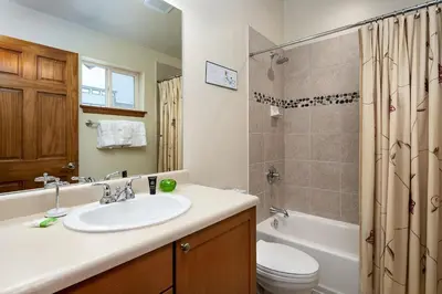 a bathroom with a sink and a toilet and a shower at Sungate Condo: Nice Frisco Location in Frisco