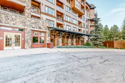 an empty street in front of a building at Zephyr Mountain Ski-In Ski-Out Condo in Winter Park