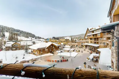 a ski resort with a snow covered courtyard and buildings at Zephyr Mountain Ski-In Ski-Out Condo in Winter Park