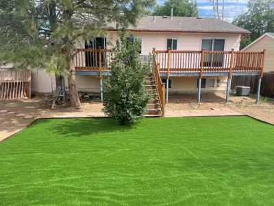 a yard of green grass with a house at MileHi Vacation Home Pet Friendly in Aurora