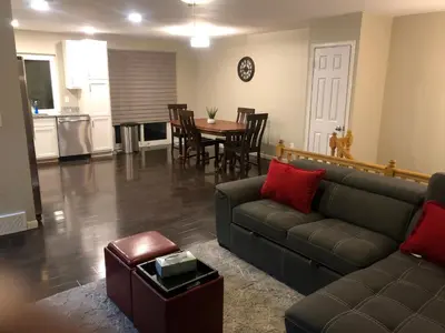 a living room with a couch and a table at MileHi Vacation Home Pet Friendly in Aurora