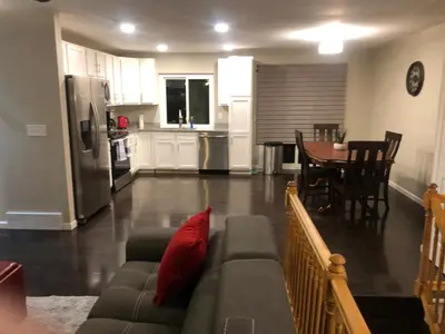 a living room and kitchen with a couch and a table at MileHi Vacation Home Pet Friendly in Aurora
