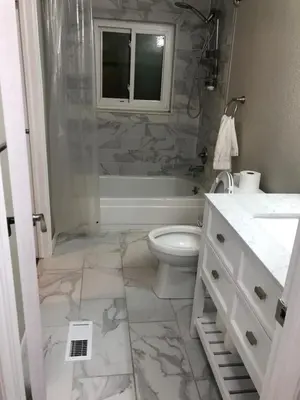 a bathroom with a tub and a toilet and a sink at MileHi Vacation Home Pet Friendly in Aurora