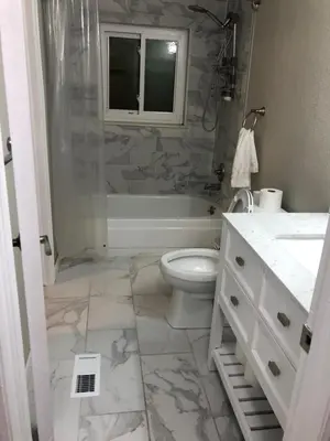 a bathroom with a tub and a toilet and a sink at MileHi Vacation Home Pet Friendly in Aurora