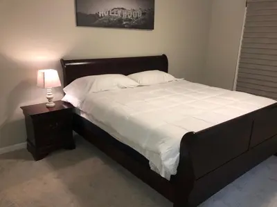 a bedroom with a bed and a nightstand with a lamp at MileHi Vacation Home Pet Friendly in Aurora