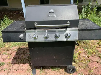 a grill sitting on the ground in a yard at MileHi Vacation Home Pet Friendly in Aurora