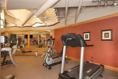 a gym with several exercise equipment in a room at 8282 Silver Mill condo in Keystone