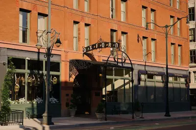 a store on a city street with a building at The Oxford Hotel in Denver