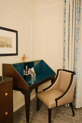 a desk with a chair next to a desk with at The Oxford Hotel in Denver