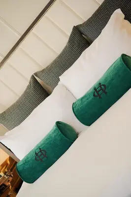 a pair of green socks on a bed at The Oxford Hotel in Denver