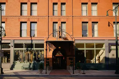 a large brick building with an entrance to a store at The Oxford Hotel in Denver