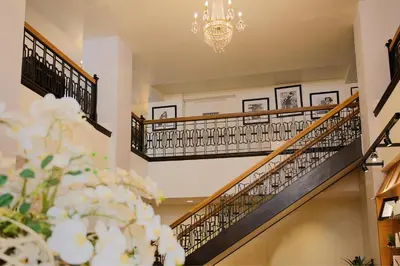 a staircase in a house with a chandelier at The Oxford Hotel in Denver