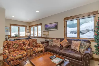a living room with a couch and a table at The Sanctuary Getaway - 192 home in Keystone