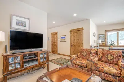 a living room with a flat screen tv at The Sanctuary Getaway - 192 home in Keystone