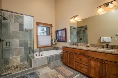 a bathroom with a tub and a sink and a shower at The Sanctuary Getaway - 192 home in Keystone