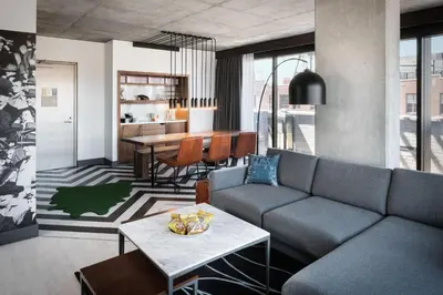 a living room with a couch and a table at The Maven Hotel at Dairy Block in Denver
