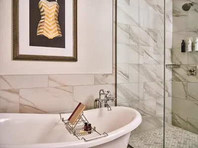 a bathroom with a bath tub and a sink at The Crawford Hotel in Denver