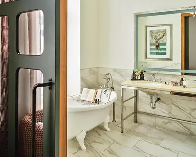 a bathroom with a tub and a sink at The Crawford Hotel in Denver