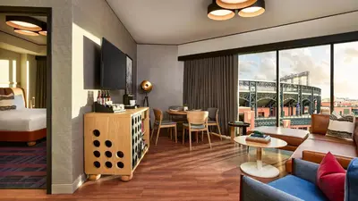 a hotel room with a bed and a living room at The Rally Hotel at McGregor Square in Denver