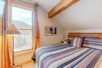 a bedroom with a bed and a window at Family - Friendly 3 Bedroom In River Run Village With Mountain View in Keystone