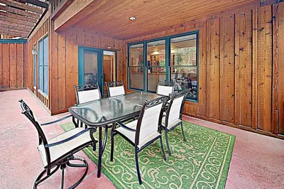 a dining room with a glass table and chairs at Family - Friendly 3 Bedroom In River Run Village With Mountain View in Keystone