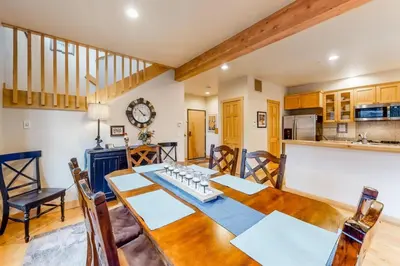 a kitchen and dining room with a table and chairs at Family - Friendly 3 Bedroom In River Run Village With Mountain View in Keystone