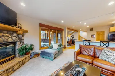 a living room with a couch and a fireplace at Family - Friendly 3 Bedroom In River Run Village With Mountain View in Keystone