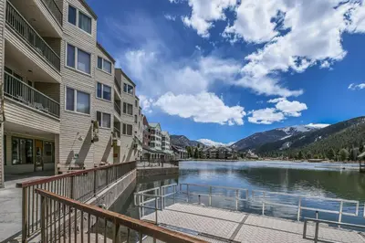 a view of the lake from the balcony of a apartment building at Lakeside 1476 by SummitCove Lodging in Keystone