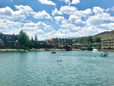 a large body of water with people in boats at Lakeside 1476 by SummitCove Lodging in Keystone