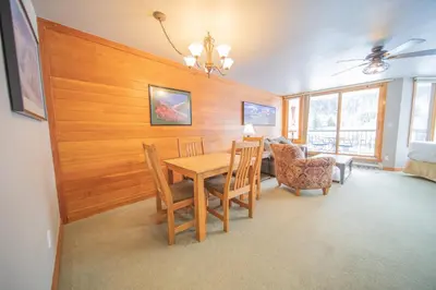 a dining room with a table and chairs at Lakeside 1476 by SummitCove Lodging in Keystone
