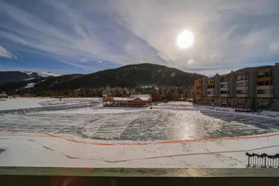 an ice skating rink in front of a building at Lakeside 1476 by SummitCove Lodging in Keystone