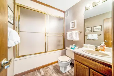 a bathroom with a sink and a toilet and a shower at Granby Condo with Views in Granby