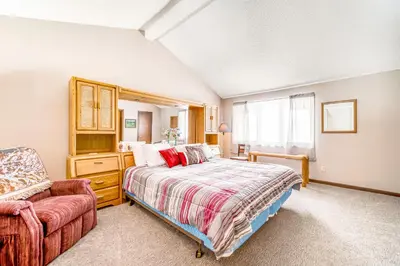 a bedroom with a bed and a chair at Granby Condo with Views in Granby