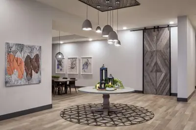 a room with a table and a dining room at Hyatt House Denver Aurora Anschutz Medical Campus in Aurora