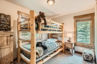 a bedroom with bunk beds and a teddy bear at Keystone Gulch Estate 1688 estate in Keystone
