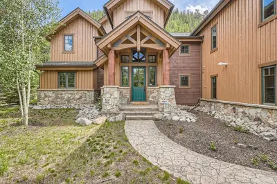 a house with a stone path leading to the front door at Keystone Gulch Estate 1688 estate in Keystone