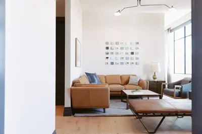 a living room with a couch and a table at Clayton Hotel & Members Club in Denver