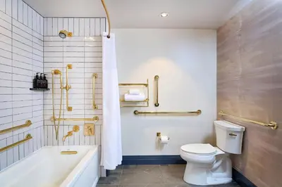 a bathroom with a tub and a toilet and a sink at Clayton Hotel & Members Club in Denver