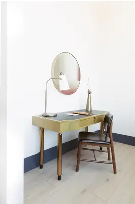 a desk with a mirror and a chair at Clayton Hotel & Members Club in Denver
