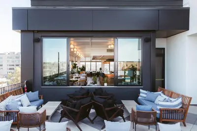 a patio with chairs and tables on a building at Clayton Hotel & Members Club in Denver