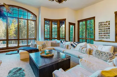 a living room with a couch and a table at Base Camp 496 in Winter Park