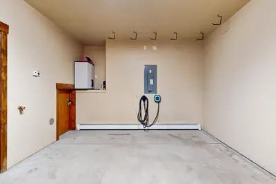 a large empty room with a refrigerator in a room at Base Camp 496 in Winter Park
