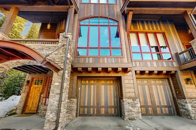 a house with two garage doors and a balcony at Base Camp 496 in Winter Park
