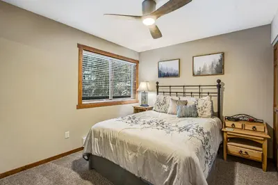 a bedroom with a bed and a ceiling fan at Winter Park Place 14 in Winter Park