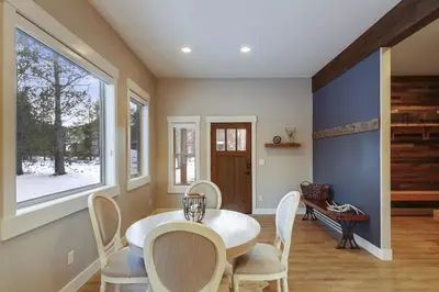 a dining room with a table and chairs and a window at Willows at Grand Park home in Fraser