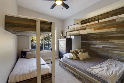 a bedroom with two bunk beds and a ceiling fan at Willows at Grand Park home in Fraser