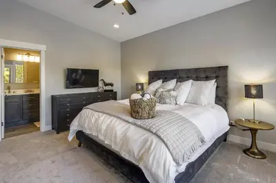 a bedroom with a large bed and a bathroom at Willows at Grand Park home in Fraser
