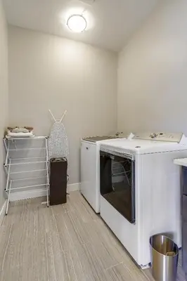 a kitchen with a washer and dryer in a room at Willows at Grand Park home in Fraser