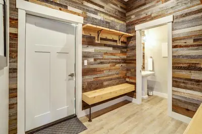 a bathroom with a wall of reclaimed wood at Willows at Grand Park home in Fraser