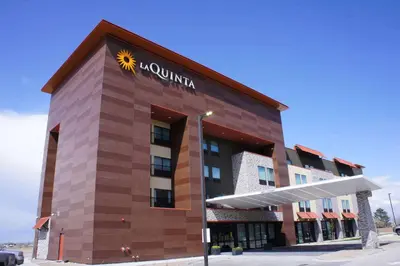 a rendering of the front of a hotel at La Quinta Inn & Suites by Wyndham Littleton-Red Rocks in Littleton